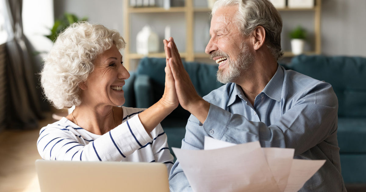 Couple high fiving after completing their expression of wishes